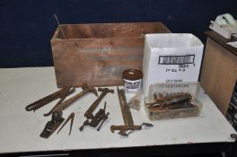A VINTAGE WOODEN CRATE containing hand tools including tin snips, bit and brace, hand drills, a
