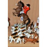 A BESWICK HUNTSMAN, HOUNDS AND FOXES, comprising huntsman on rearing horse, model no 868, style two,