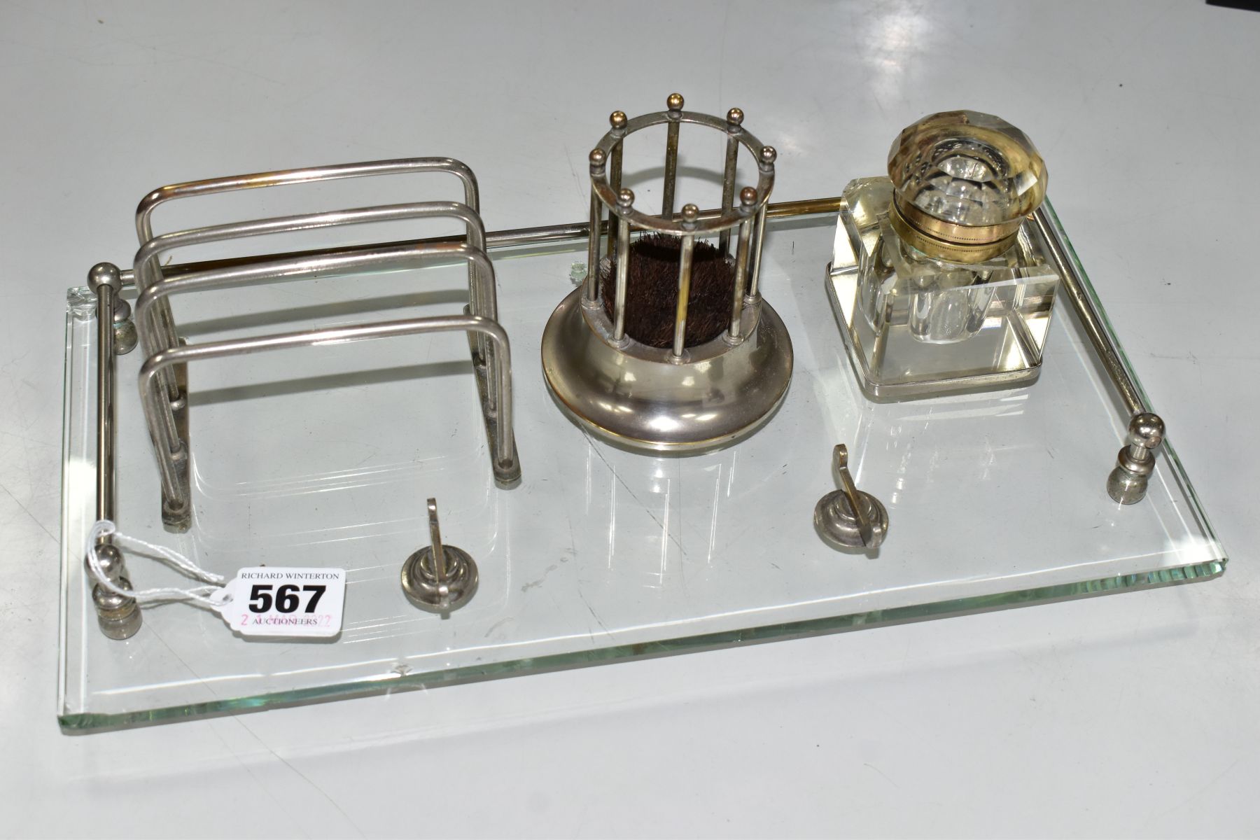 AN EARLY 20TH CENTURY GLASS AND CHROMED METAL DESK STAND OF RECTANGULAR FORM, fitted with a pen