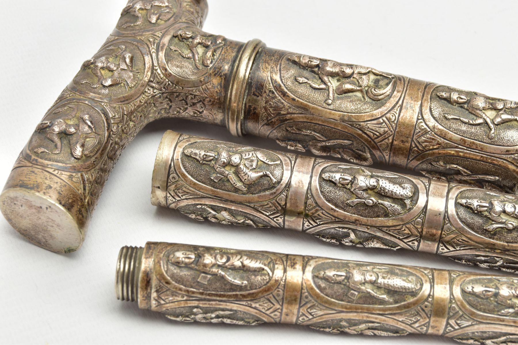 AN ASIAN WHITE METAL WALKING CANE, embossed religious figures throughout, can be taken apart into - Image 6 of 7