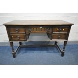 A REPRODUCTION OAK DRESSING TABLE, long central drawer flanked by two banks of two drawers, width