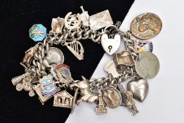 A SILVER CHARM BRACELET, a curb link bracelet fitted with a heart padlock clasp and safety chain,
