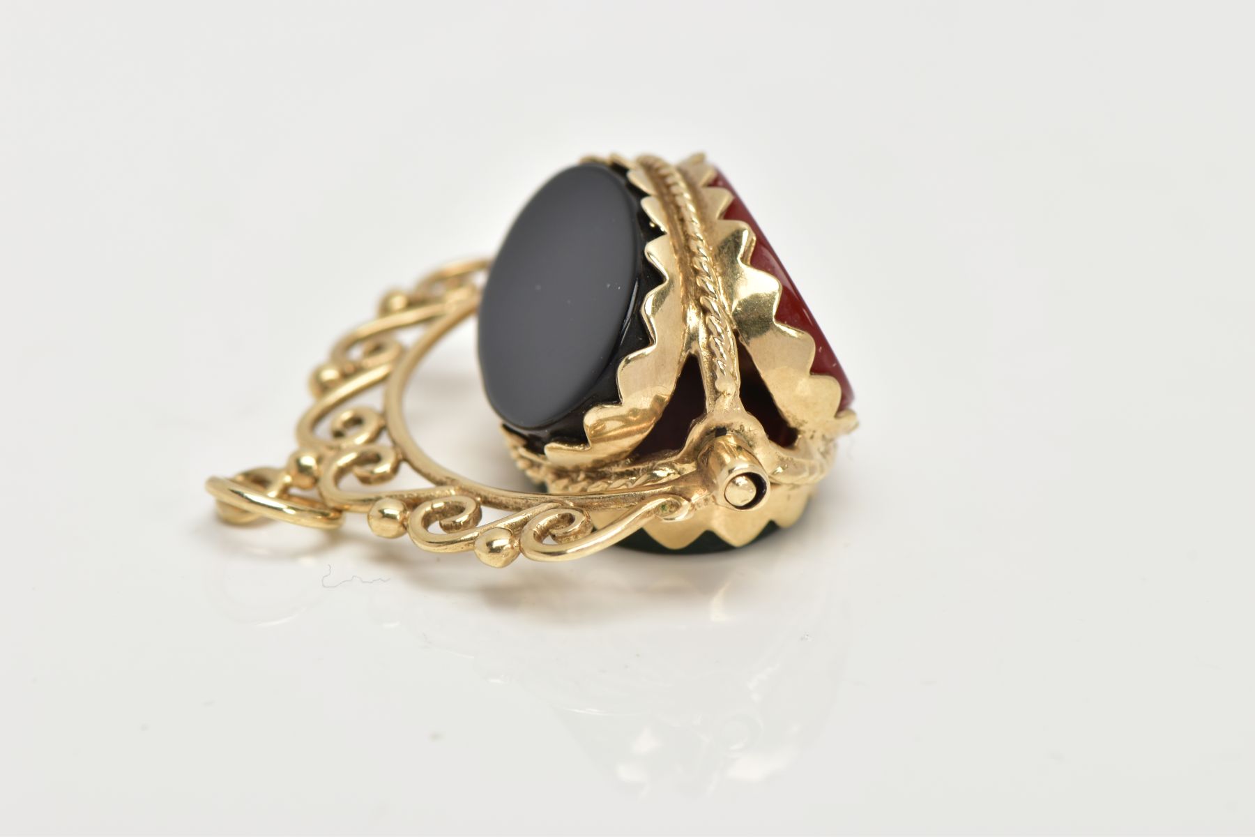 A 9CT GOLD SWIVEL FOB, set with oval cut onyx, carnelian and bloodstone panels, openwork scroll - Image 4 of 4