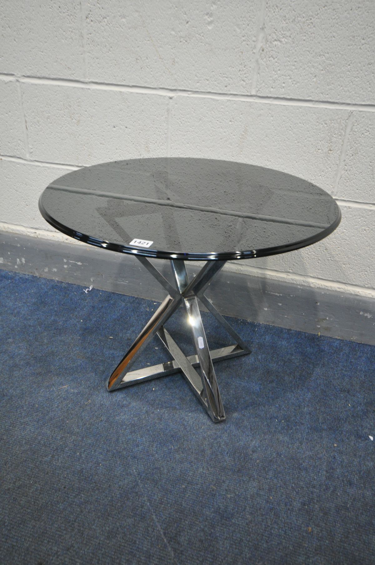 A MODERN SMOKED CIRCULAR GLASS OCCASIONAL TABLE, on a shaped chrome frame, diameter 59cm x height