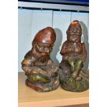 TWO CAST CONCRETE GARDEN GNOMES, one is a jovial laughing figure, the other is reading a book,