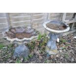 A MODERN COMPOSITE BIRD BATH in the form of shell supported by a twisted base, height 48cm, along