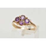 A 9CT GOLD AMETHYST RING, designed with four circular cut amethysts each bezel set into a lozenge