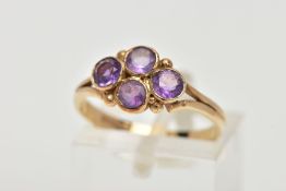 A 9CT GOLD AMETHYST RING, designed with four circular cut amethysts each bezel set into a lozenge