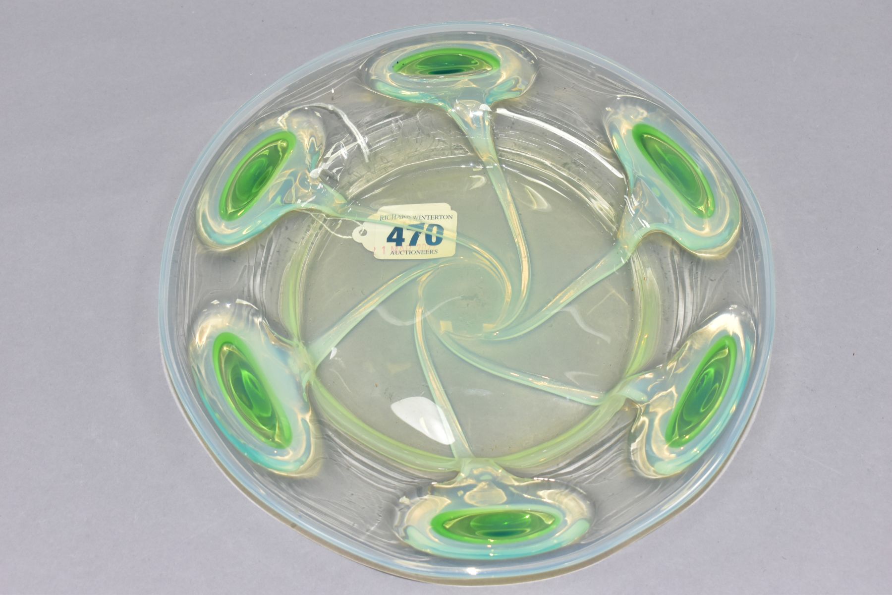A STUART-STYLE GLASS BOWL, featuring a wide rim with raised uranium glass peacock feather pattern,