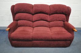 A RED UPHOLSTERED THREE SEATER SETTEE, length 177cm