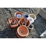 A LARGE QUANTITY OF TERRACOTTA GARDEN POTS, of various sizes, along with a wrought iron planter, and