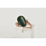 A YELLOW METAL TURQUOISE RING, set with an oval green turquoise cabochon, collet mounted, within