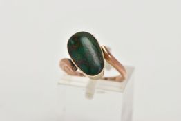 A YELLOW METAL TURQUOISE RING, set with an oval green turquoise cabochon, collet mounted, within
