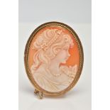 A 9CT GOLD CAMEO BROOCH, an oval shell cameo depicting a lady in profile in a collet mount with a