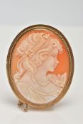 A 9CT GOLD CAMEO BROOCH, an oval shell cameo depicting a lady in profile in a collet mount with a