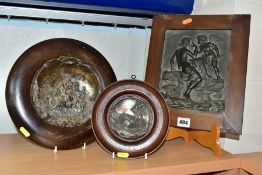 AN OAK FRAMED SILVER PLATED PLAQUE OF TONDO FORM, depicting Mary, Joseph and the baby Jesus with a