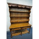 A PINE DRESSER, with five drawers, over five turned supports united by an undershelf, width 146cm