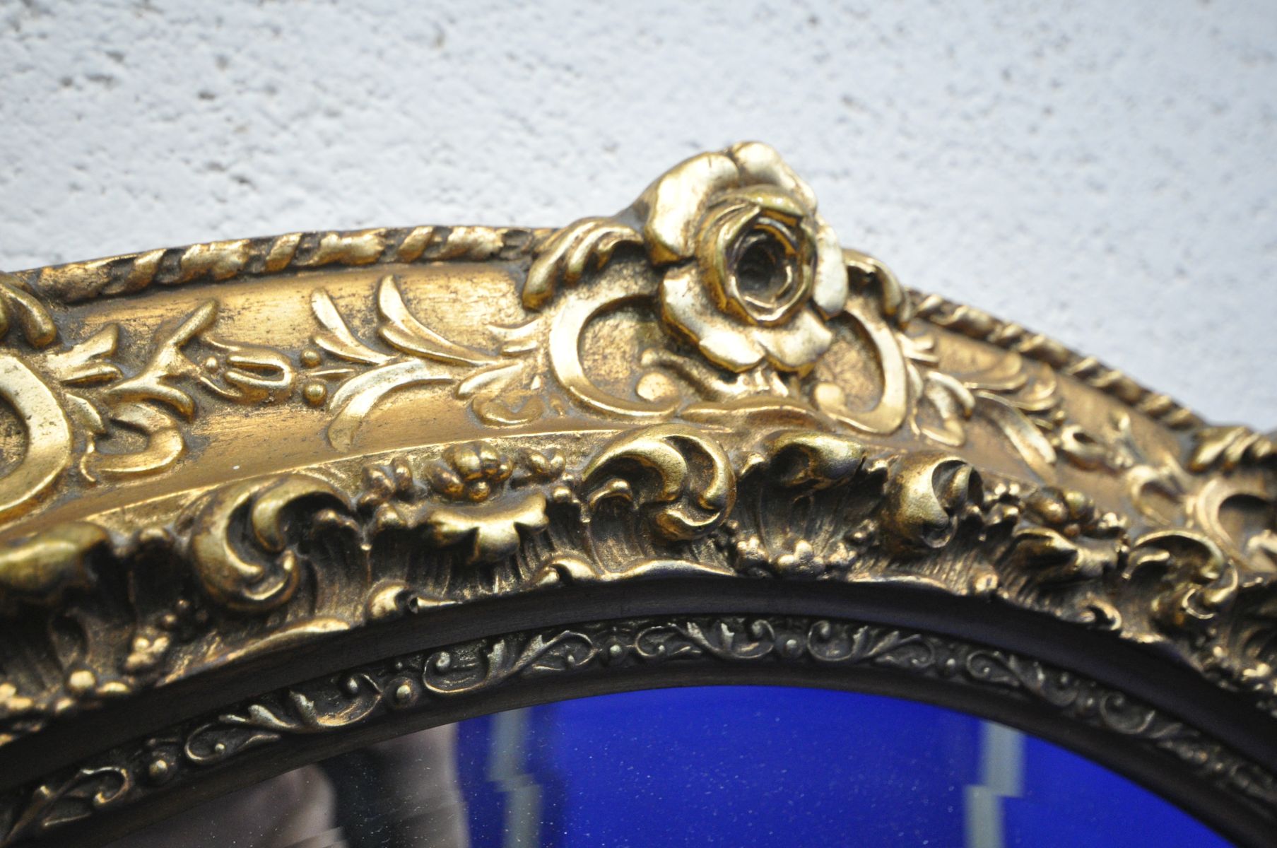 A LATE 20TH CENTURY GILT FRAMED OVAL WALL MIRROR, with foliate and rose head decorations, 97cm x - Image 2 of 3