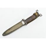 AMERICAN WORLD WAR TWO ERA M3 FIGHTING KNIFE, in metal and canvas scabbard, the knife cross guard is