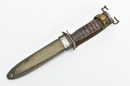 AMERICAN WORLD WAR TWO ERA M3 FIGHTING KNIFE, in metal and canvas scabbard, the knife cross guard is
