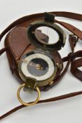 A WORLD WAR ONE ERA FIELD COMPASS, WAR OFFICE, DATED 1917, in its correct brown leather carrying