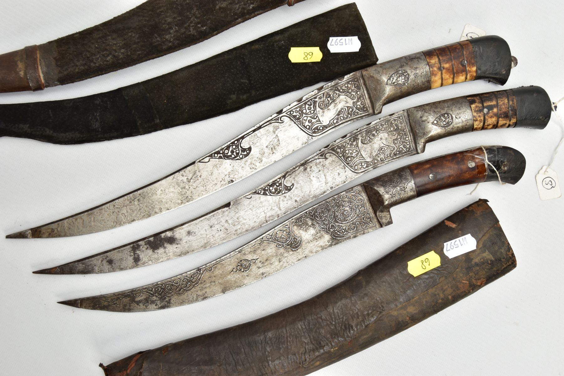 THREE INDIAN/ASIAN short daggers all with skin covered wooden scabbards, all curved and etched - Image 7 of 9