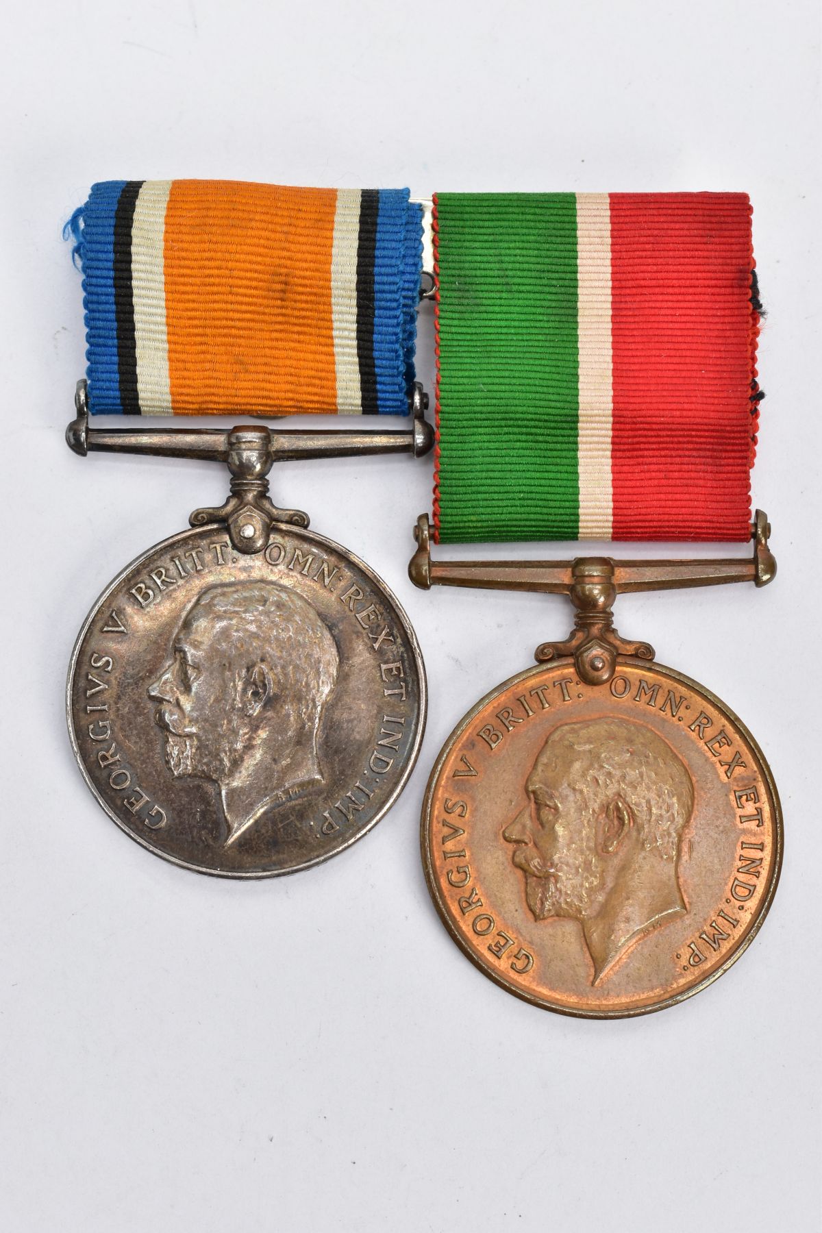 A MERCHANTILE MARINE WAR & BRITISH WAR MEDAL PAIR, on a wearing bar, named John P Cain,