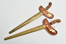 TWO MALAY/INDONESIAN KRIS DAGGERS, possibly a pair, ornate metal sheaths(warangka) carved wooden