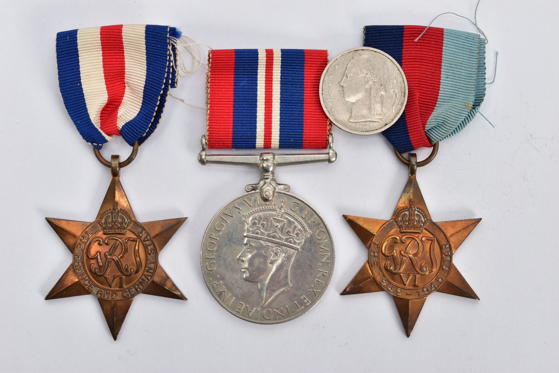 A SMALL BOX CONTAINING THREE WORLD WAR TWO MEDALS, as follows 1939-45, France & Germany Stars, & War