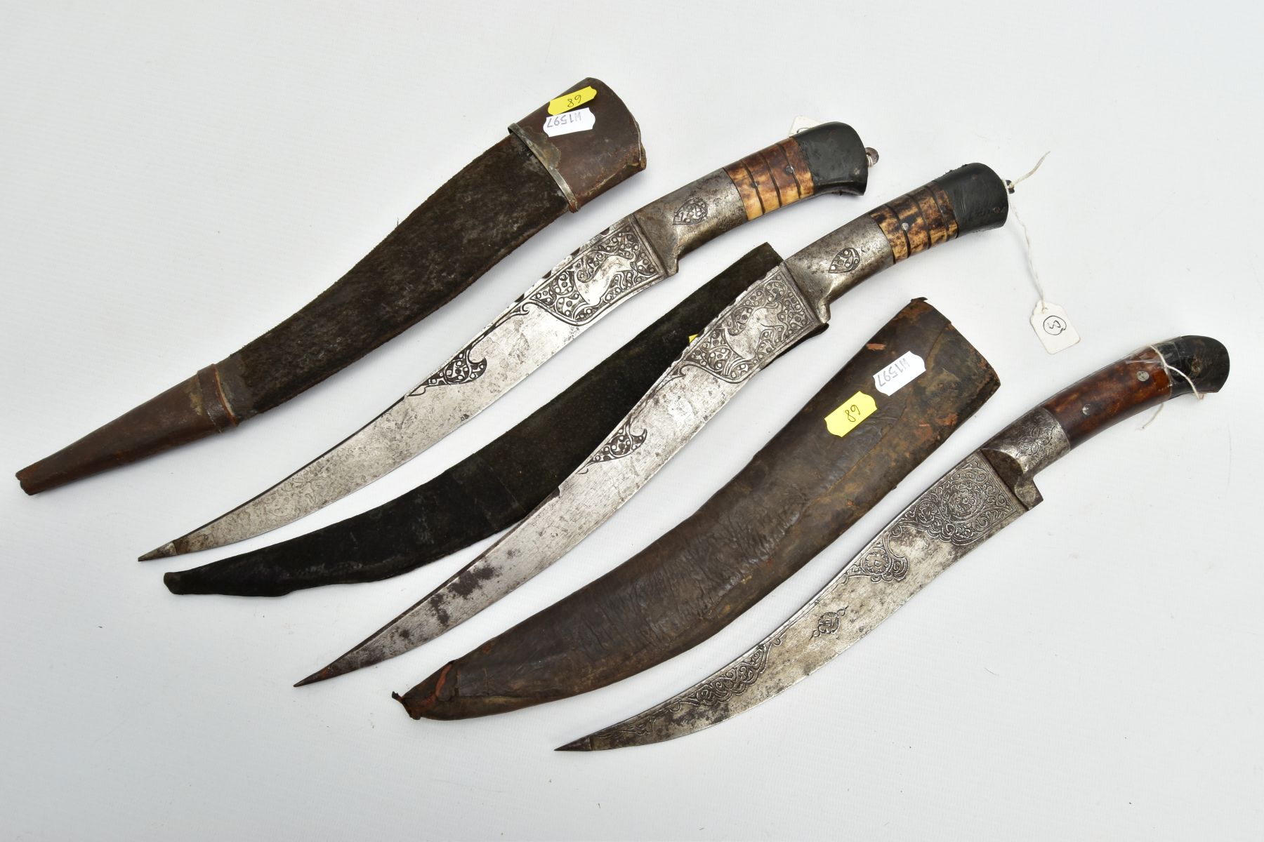 THREE INDIAN/ASIAN short daggers all with skin covered wooden scabbards, all curved and etched - Image 6 of 9