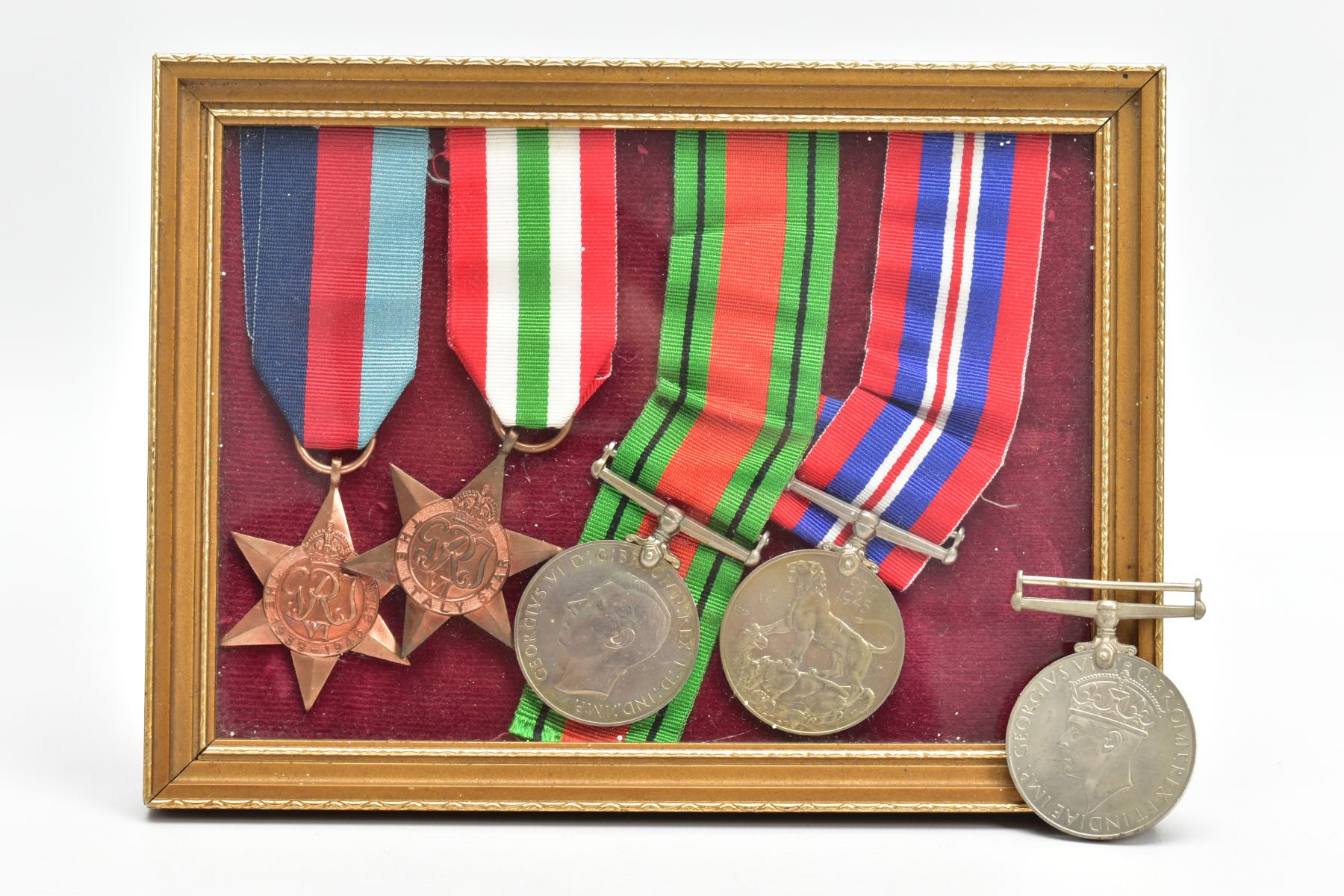 SMALL GLAZED FRAME CONTAINING WORLD WAR TWO MEDALS, as follows 1939-45, Italy Stars, Defence & War