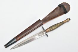 A FAIRBAIRN-SYKES FIGHTING KNIFE, complete with leather scabbard, this example is believed to be a
