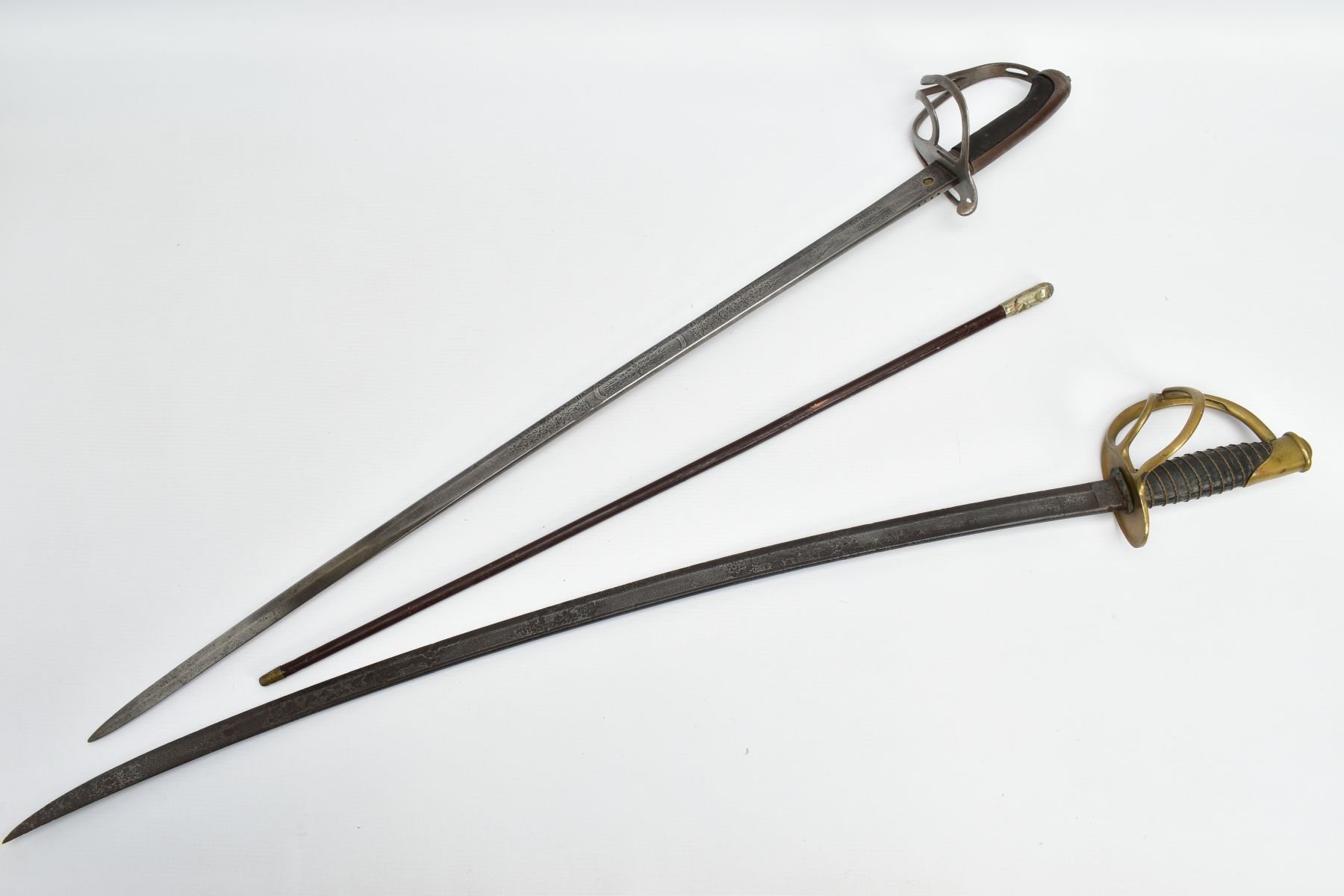 TWO MILITARY SWORDS AND OFFICERS SWAGGER STICK, a Royal Artillery officers sword by Henry