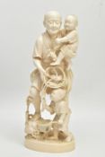 A LARGE JAPANESE MEIJI PERIOD IVORY OKIMONO, of a fisherman standing holding a child in his arms and