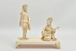 A JAPANESE MEIJI PERIOD CARVED IVORY GROUP ON A RECTANGULAR IVORY STAND, the figures comprising a