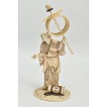 A JAPANESE MEIJI PERIOD IVORY AND WOODEN OKIMONO, of as man in detailed kimono and wearing gita,