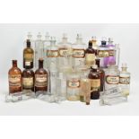 A COLLECTION OF THIRTY ONE GLASS PHARMACY BOTTLES, twenty four clear and seven brown, the brown