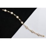 A MODERN 18CT GOLD DIAMOND FLOWER CLUSTER LINK PANEL BRACELET, comprising of seven round clusters