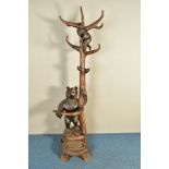 A LATE 19TH CENTURY BLACK FOREST HALL STAND, with the mother bear wrapped around the base of the