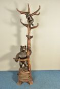 A LATE 19TH CENTURY BLACK FOREST HALL STAND, with the mother bear wrapped around the base of the