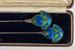 A PAIR OF ART NOUVEAU SILVER AND ENAMEL HATPINS, decorated in blue and green enamel, together with