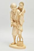 A JAPANESE MEIJI PERIOD IVORY OKIMONO, of a man holding a child on his back and a tortoise on a rope