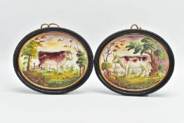 A PAIR OF 19TH CENTURY STAFFORDSHIRE POTTERY PLAQUES OF OVAL FORM, moulded in relief with a cow