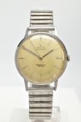 A STAINLESS STEEL ZENITH AUTOMATIC WRISTWATCH, deteriorating silvered dial with baton markers,