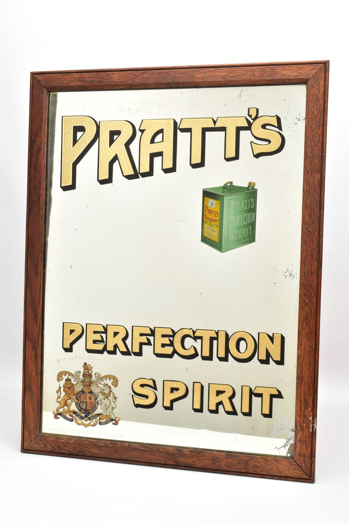 AN EARLY 20TH CENTURY PRATT'S PERFECTION SPIRIT ADVERTISING MIRROR IN A RECTANGULAR OAK FRAME,