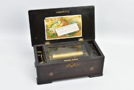 A LATE 19TH CENTURY SWISS MUSIC BOX IN A ROSEWOOD STAINED CASE, the hinged lid pinned with a printed