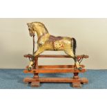 A LATE 19TH /EARLY 20TH CENTURY PAINTED WOOD ROCKING HORSE ON A PINE TRESTLE BASE IN THE STYLE OF