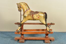 A LATE 19TH /EARLY 20TH CENTURY PAINTED WOOD ROCKING HORSE ON A PINE TRESTLE BASE IN THE STYLE OF