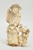 A JAPANESE MEIJI PERIOD IVORY OKIMONO, of a man carrying a large toad on his shoulders, a young