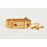 A LATE VICTORIAN GOLD, DIAMOND AND RUBY SCARF CLIP, of buckle design, set with an old cut diamond